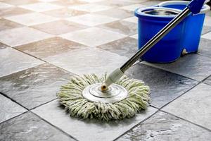 Clean tile floors with mops and floor cleaning products. photo