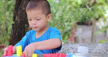 A girl and a brother are playing with plastic puzzles video