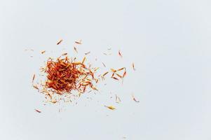 Red saffron threads on white background photo