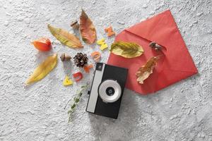 Autumn flat lay layout with vintage camera, envelope photo