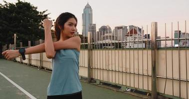 Asia athlete lady exercises doing stretch work out in urban. photo