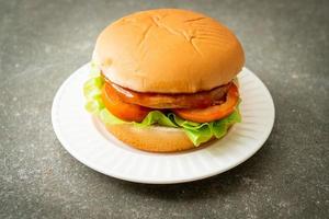 Chicken burger with sauce on plate photo