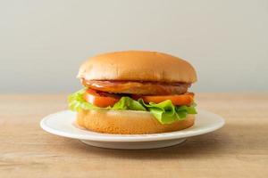 Chicken burger with sauce on plate photo