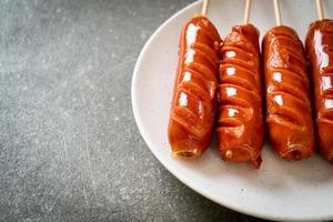 Fried sausage skewer on plate photo