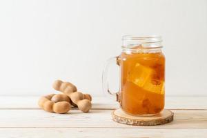 Delicious sweet drink tamarind juice and ice cube photo