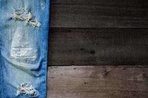Blue jeans lack and jeans texture on the wooden floor photo