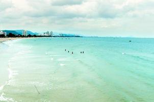 The view of the sand beach and sea wave with rock and reef on morning photo