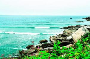 The view of the sand beach and sea wave with rock and reef on morning photo