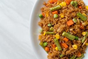 Fried rice with green peas, carrot and corn photo
