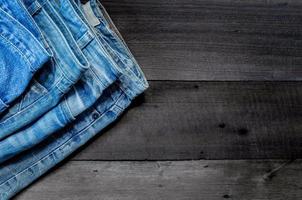 Blue jean and jean lack texture on table, Jeans are overlapping. photo