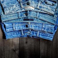 Blue jean and jean lack texture on table, Jeans are overlapping. photo