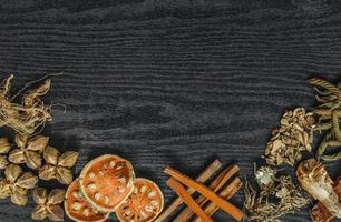 Dried herbs and dried bael fruit, Slices of bael fruit on table. photo