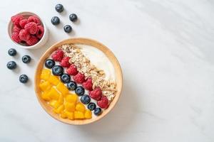 Homemade yogurt bowl with raspberry, blueberry, mango and granola photo