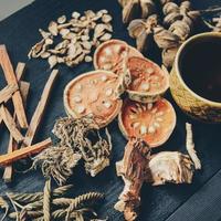 Dried herbs and dried bael fruit, Slices of bael fruit on table. photo