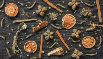 Dried herbs and dried bael fruit, Slices of bael fruit on table. photo