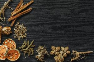 Dried herbs and dried bael fruit, Slices of bael fruit on table. photo