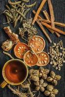 Dried herbs and dried bael fruit, Slices of bael fruit on table. photo