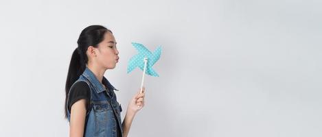 Teenage woman and paper windmill toys photo