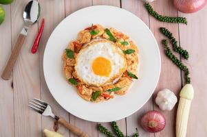 Stir fried chili paste with chicken and rice fried eggs photo