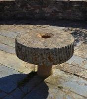 Round stone antique table adorning a courtyard of an ancient building photo