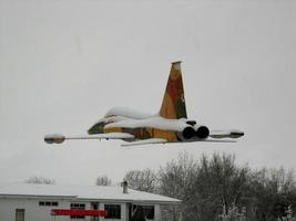 Soria, Spain, Sep 26, 2021 - War plane flying on a snowy day photo