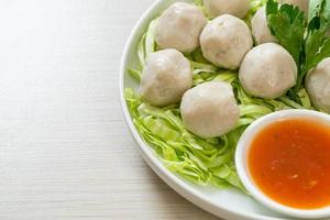 Boiled fish balls with spicy sauce photo