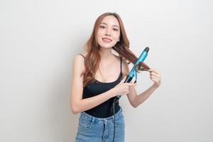 Portrait beautiful Asian woman using hair curler or curling iron photo