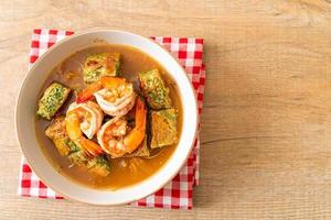 Sour soup made of tamarind paste with shrimps and vegetable omelet photo
