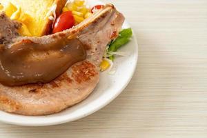 Pork chop steak with chips and mini salad photo