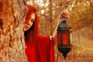 Woman holding a lantern with a candle photo