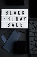 Black Friday sale concept. Monochromatic flatlay on dark background photo