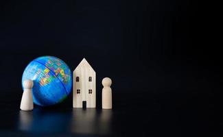 Model wooden houses and miniature globes Blank on a black background. photo