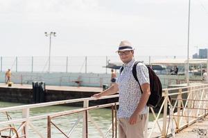 Tourist walking in the sea port, boats and yachts on the background photo