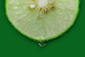 Lemon and lime slice and fresh citrus fruit on green background. photo