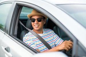 Young handsome asian man driving car to travel.