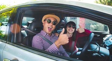Happy moment couple asian man and woman sitting in car. photo