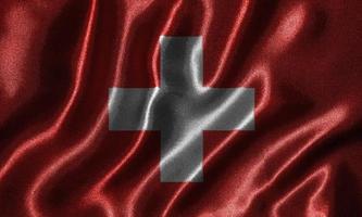 papel pintado con la bandera de Suiza y la bandera ondeando por la tela. foto
