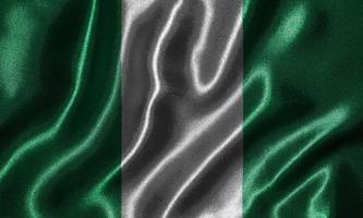 papel tapiz de la bandera de nigeria y bandera ondeando por tela. foto