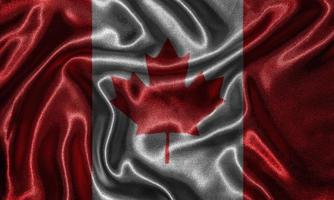 papel tapiz de la bandera de Canadá y bandera ondeando por la tela. foto