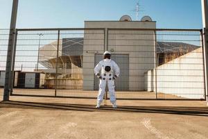 Astronaut on futuristic city background, glimpse at future photo