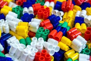 Multicolored plastic building blocks as a background texture photo