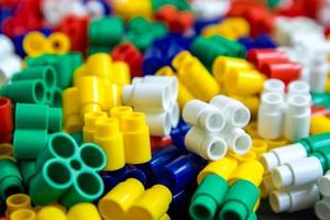 Multicolored plastic building blocks as a background texture photo