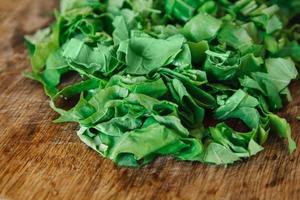 Fresh bright green spinach on a wooden board photo