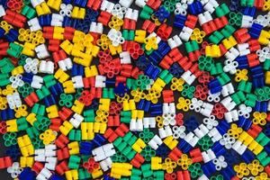 Multicolored plastic building blocks as a background texture photo