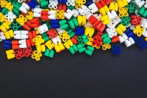 Multicolored plastic blocks on a black background photo