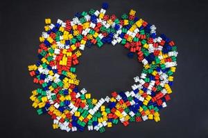 Multicolored plastic blocks on a black background photo