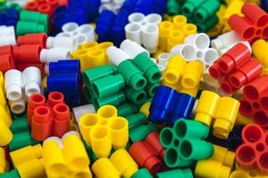 Multicolored plastic building blocks as a background texture photo