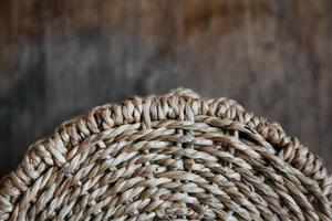 Element of a round wicker basket on a wooden background photo
