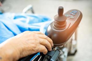 Asian senior woman patient on electric wheelchair in hospital photo