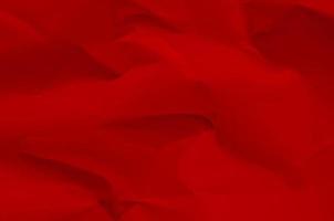 Red background and wallpaper by crumpled paper texture and free space. photo